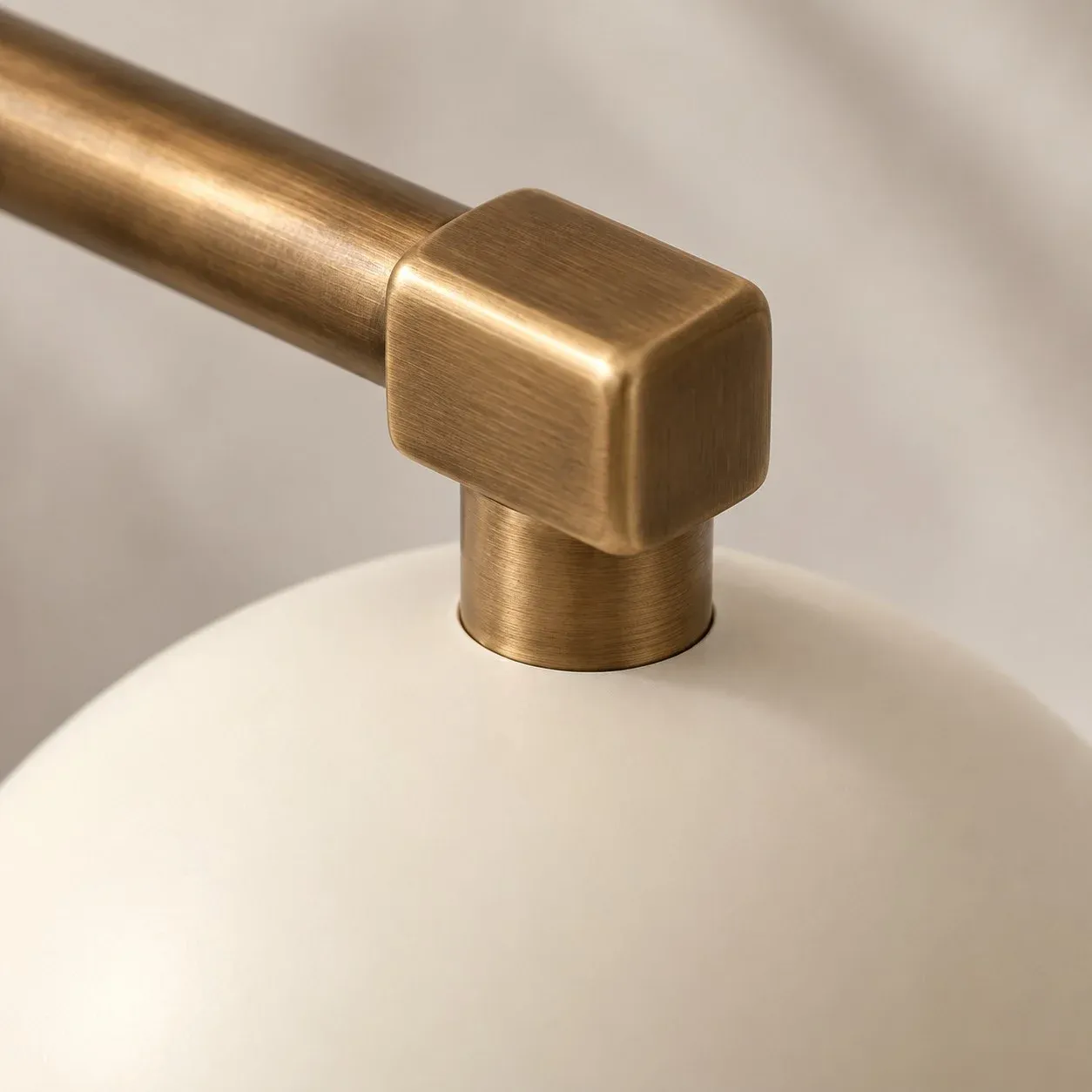 Square brass joint connecting the arm to the shade