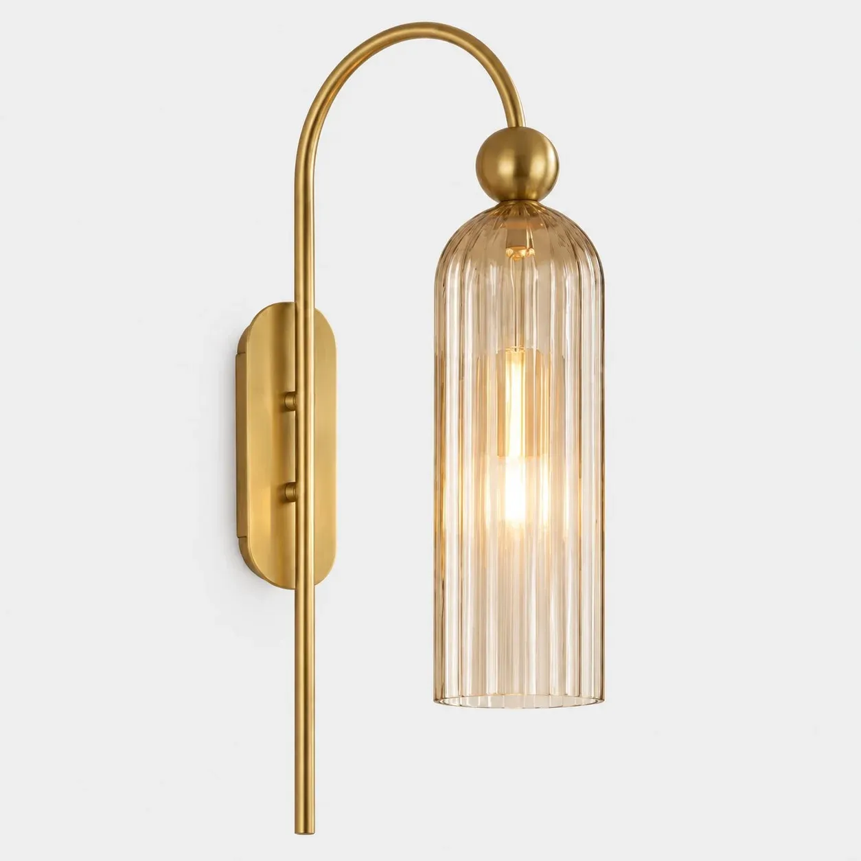 Brass arch wall sconce with clear ribbed glass cylinder
