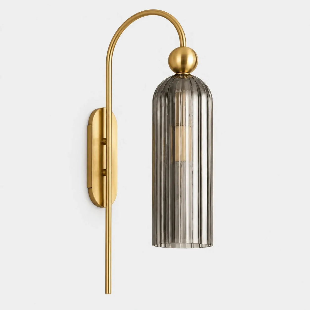 Brass arch wall sconce with gray ribbed glass cylinder