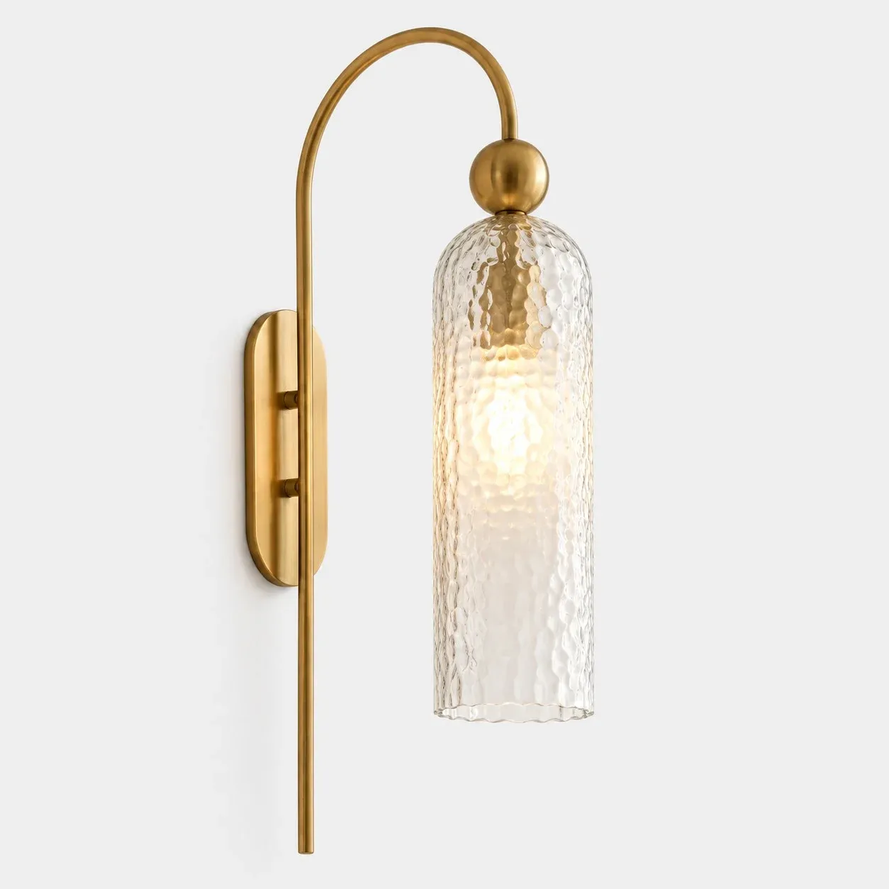 Brass arch wall sconce with hammered glass cylinder
