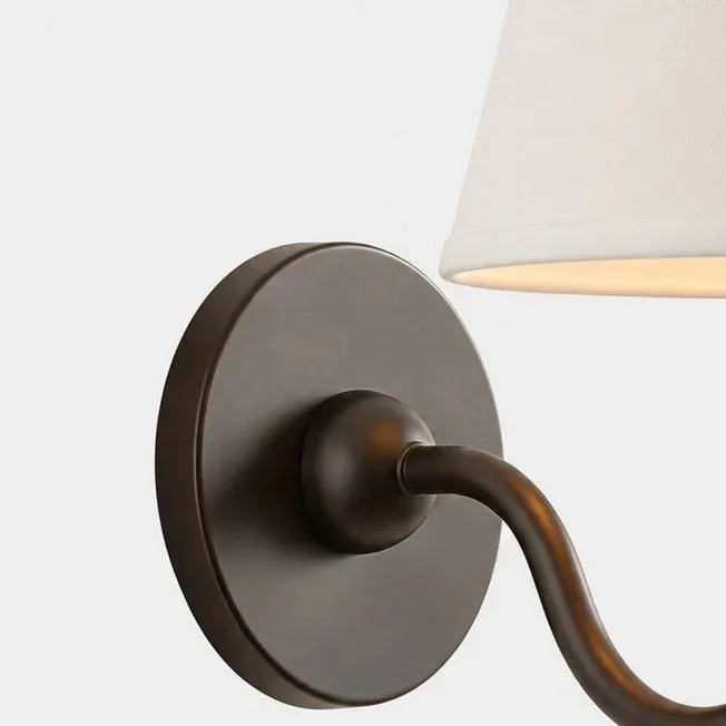 Round metal wall plate with a dark bronze finish