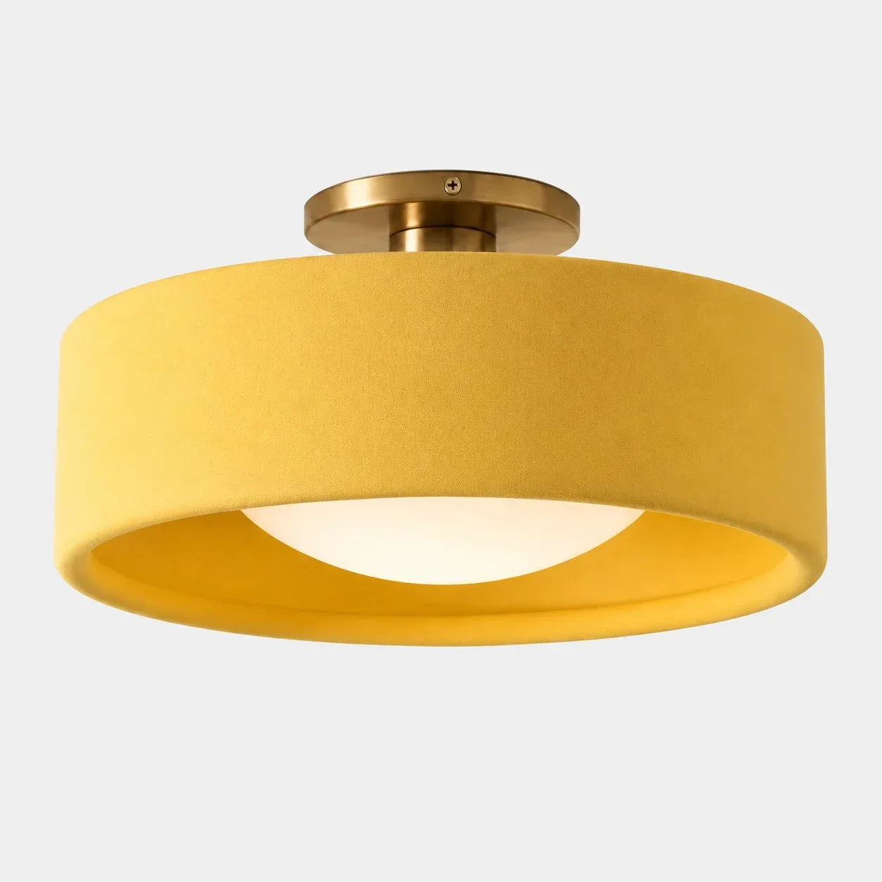 Yellow porcelain drum flush mount with a gold canopy