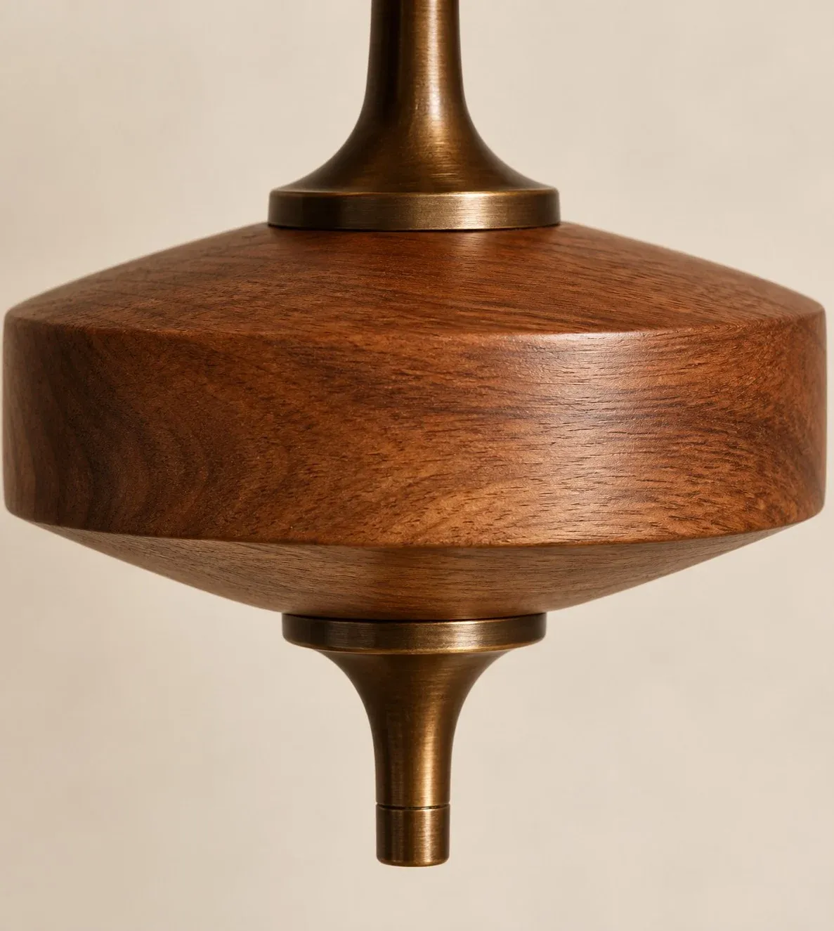 Turned walnut wood disk with antique brass finial