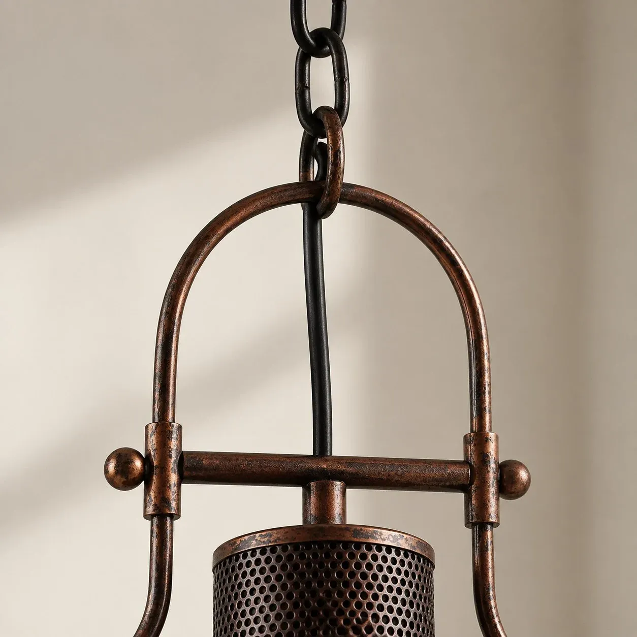 Chain hooked to the arched metal handle of the pendant