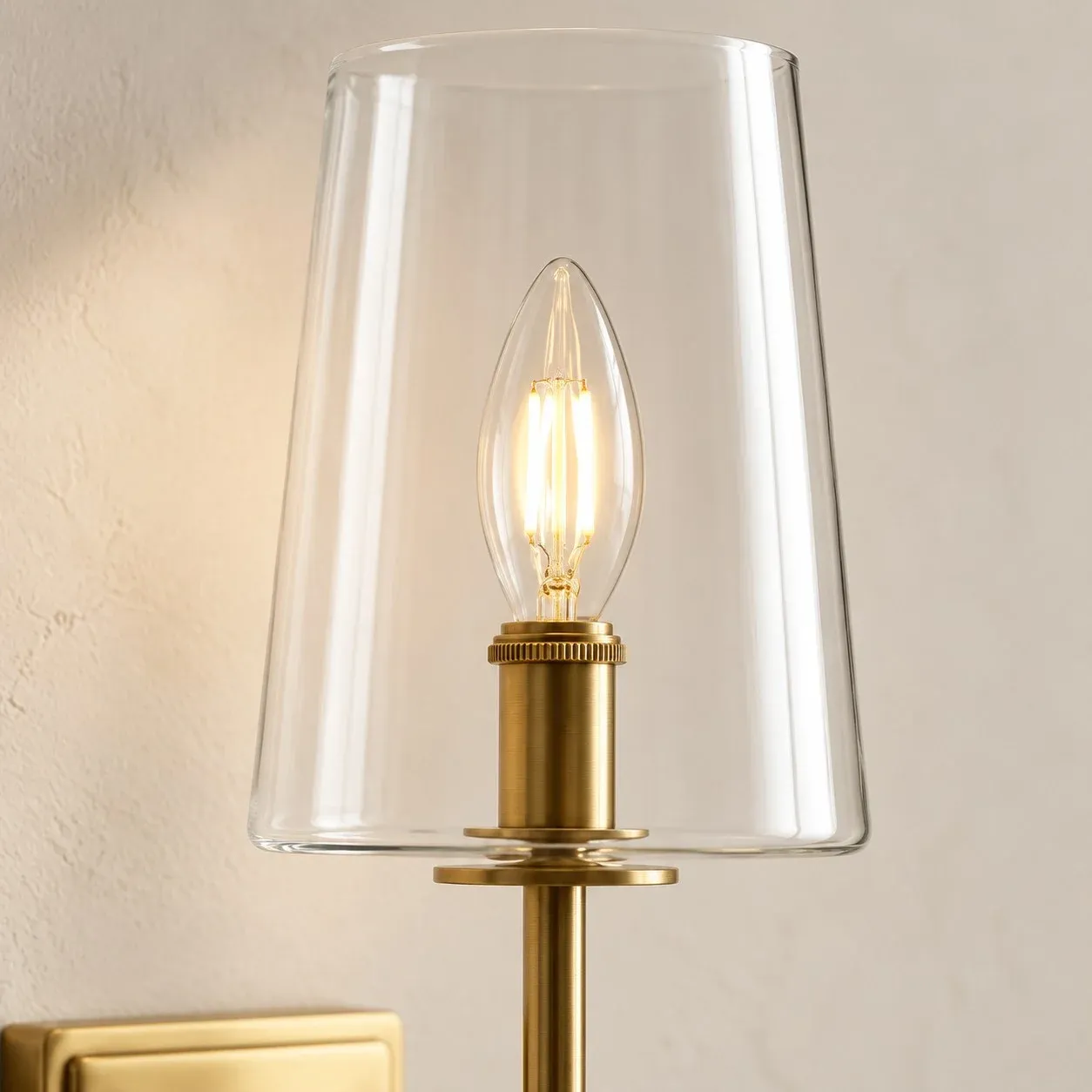 Clear glass cup around an E12 candle bulb