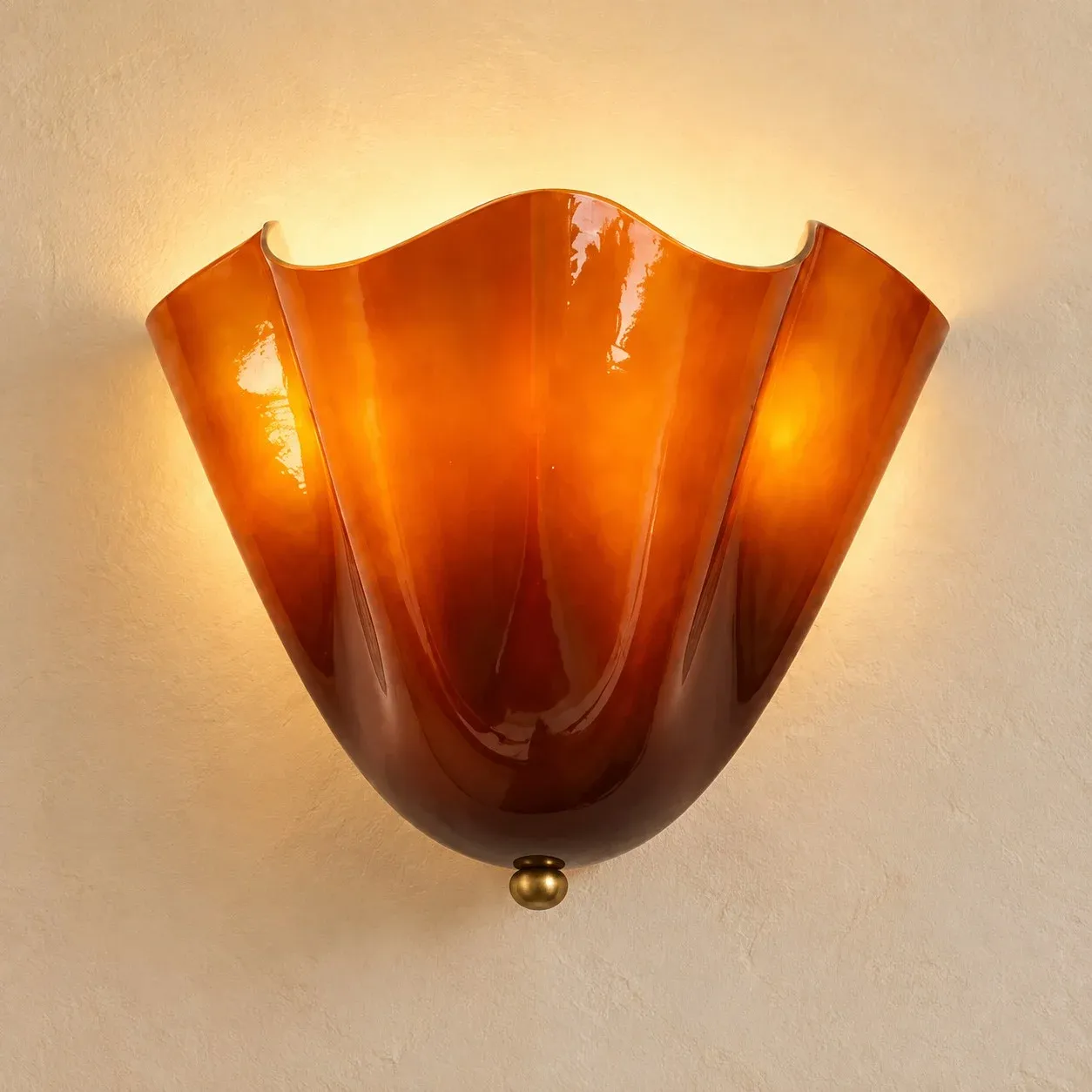 Amber seashell wall sconce mounted on a cream wall