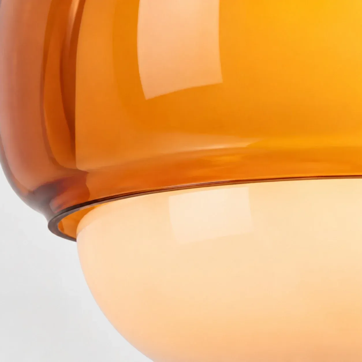 Amber outer glass rim meeting the cream inner bowl