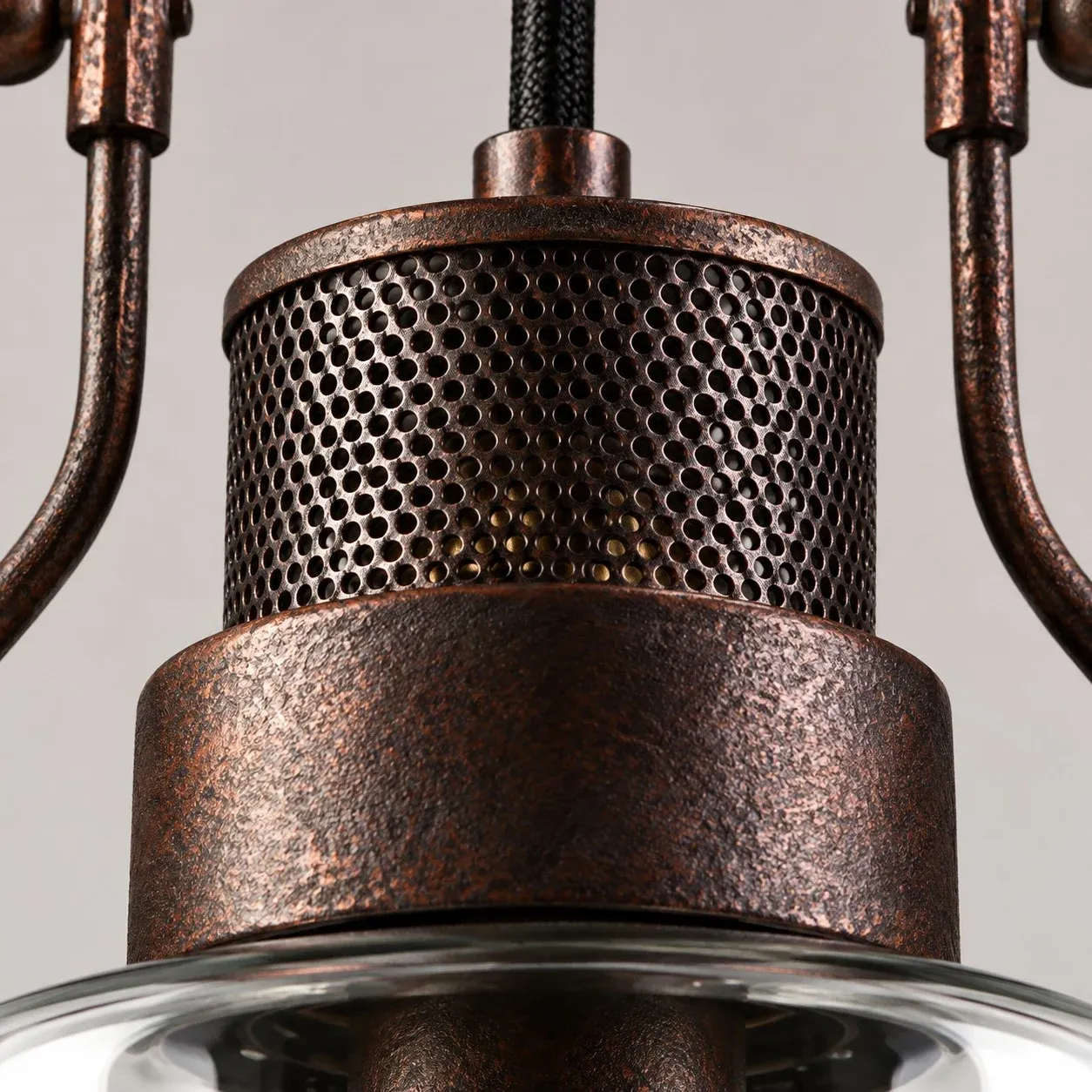 Perforated rust metal cap above the glass jar