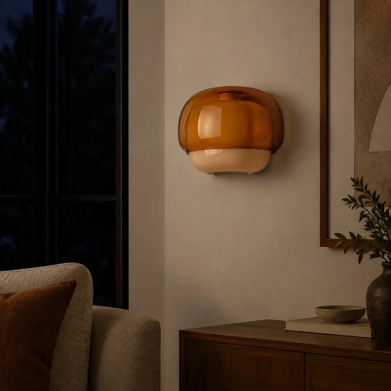 Orange glass wall sconce on a living-room wall with the inner bowl unlit
