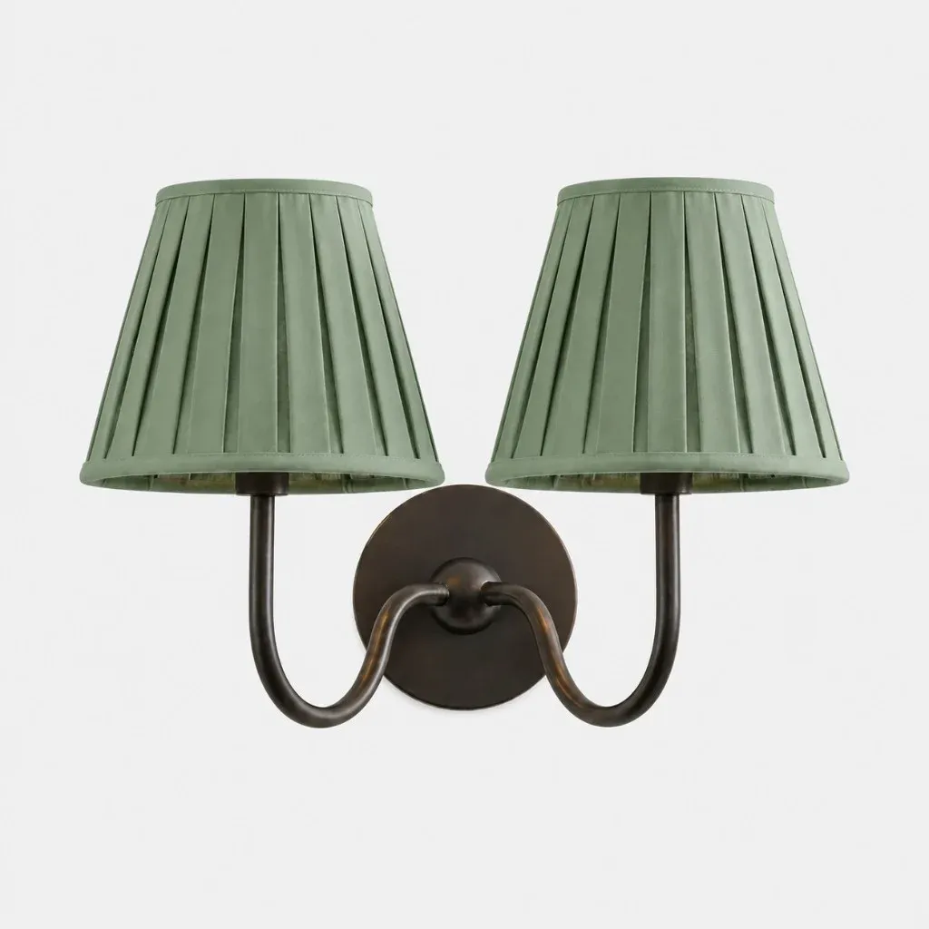 Two-head matte black wall sconce with a sage green pleated fabric shade