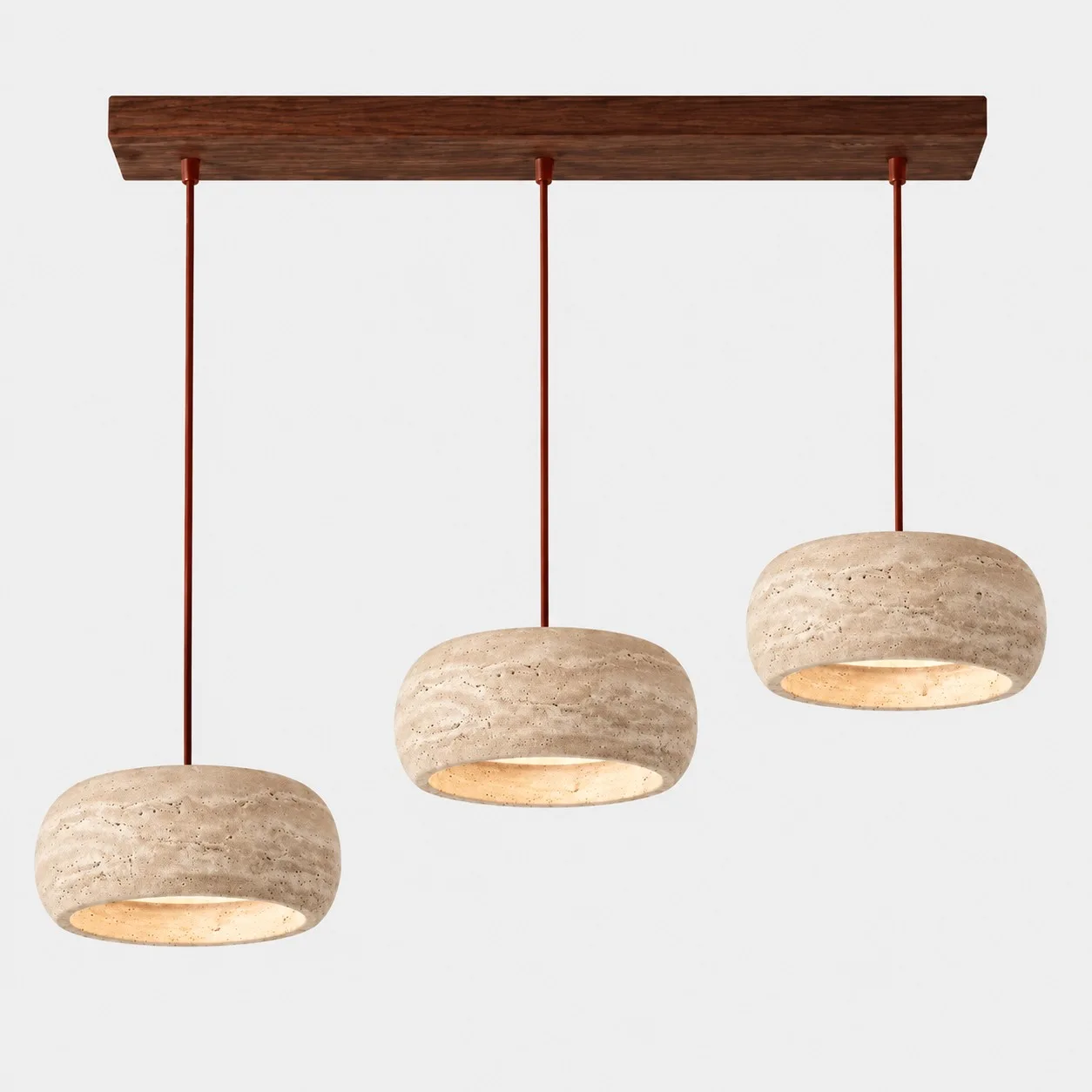 Three rounded travertine pendants on a walnut bar