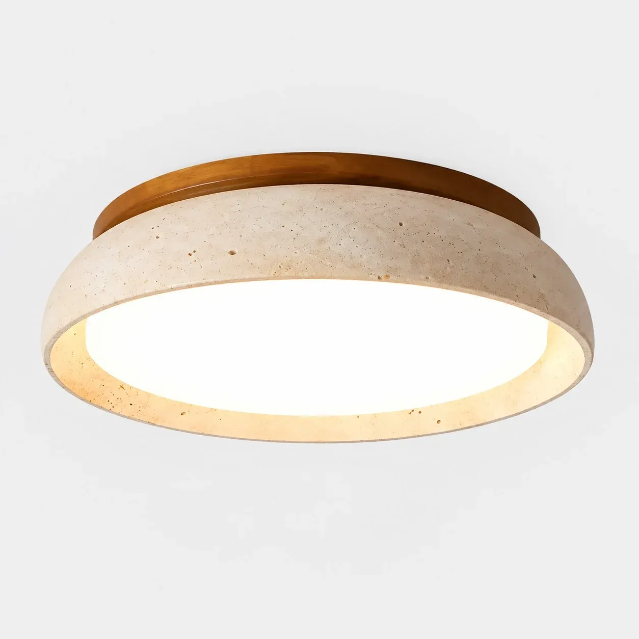 Classic travertine flush mount with a wood ring and a lit diffuser
