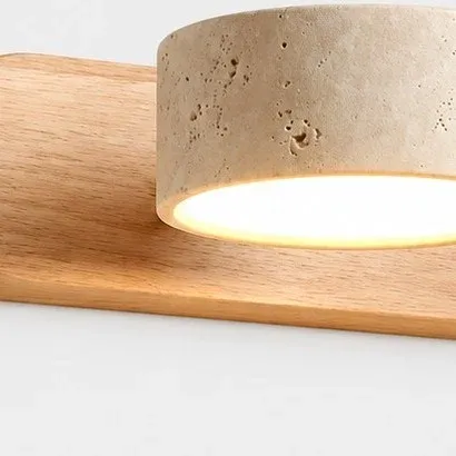Close view of a travertine shade and pale wood grain