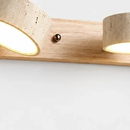 Brass knob between two travertine shades set at different angles