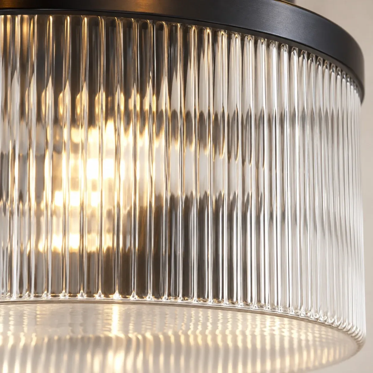 Vertical ribs in clear glass under a black ring