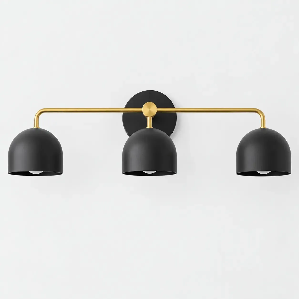 Brass three-head vanity sconce with black dome shades
