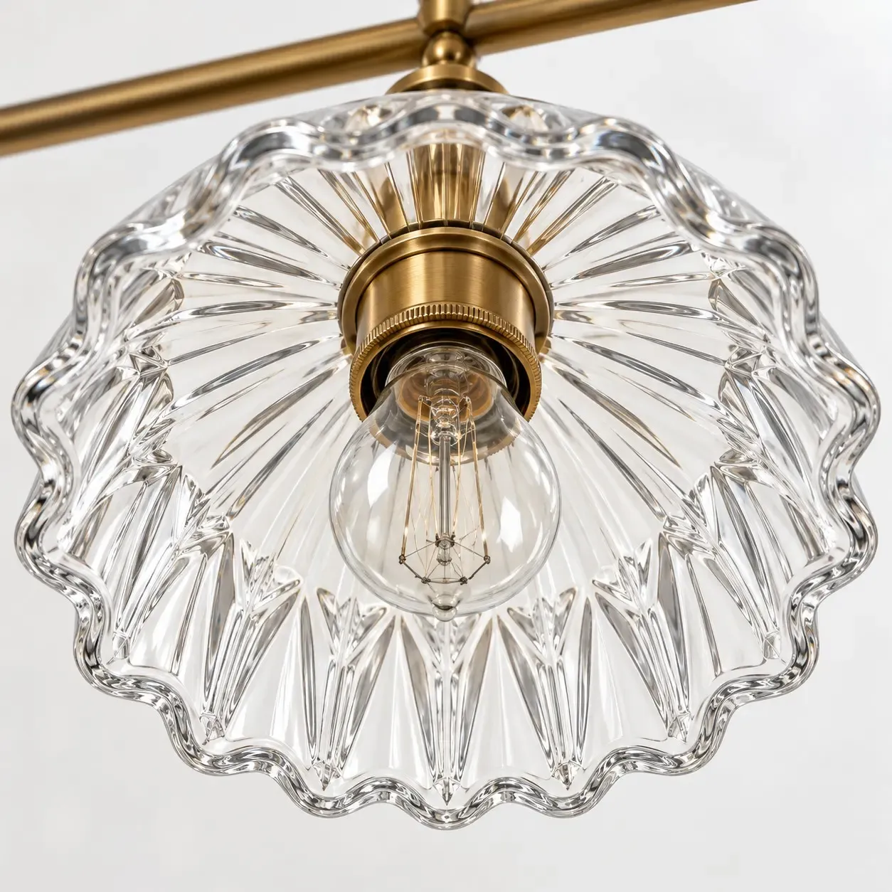 Underside of one fluted glass shade with a scalloped rim