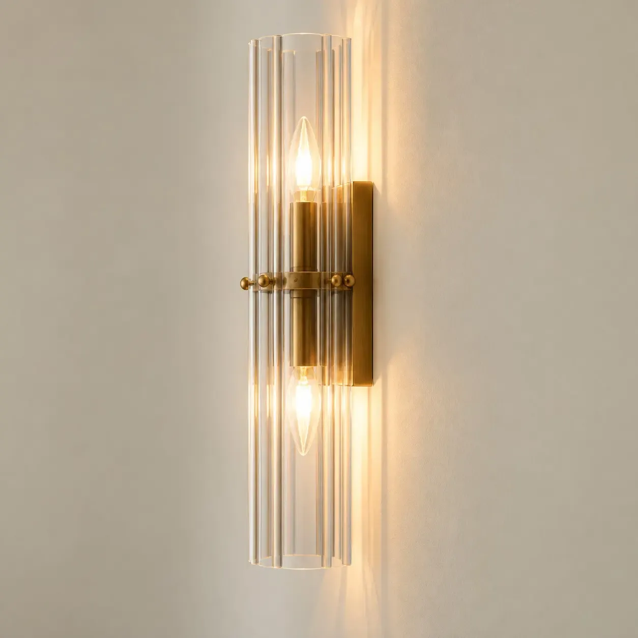 Side view of the tumbled brass 2-light sconce on a rectangular backplate