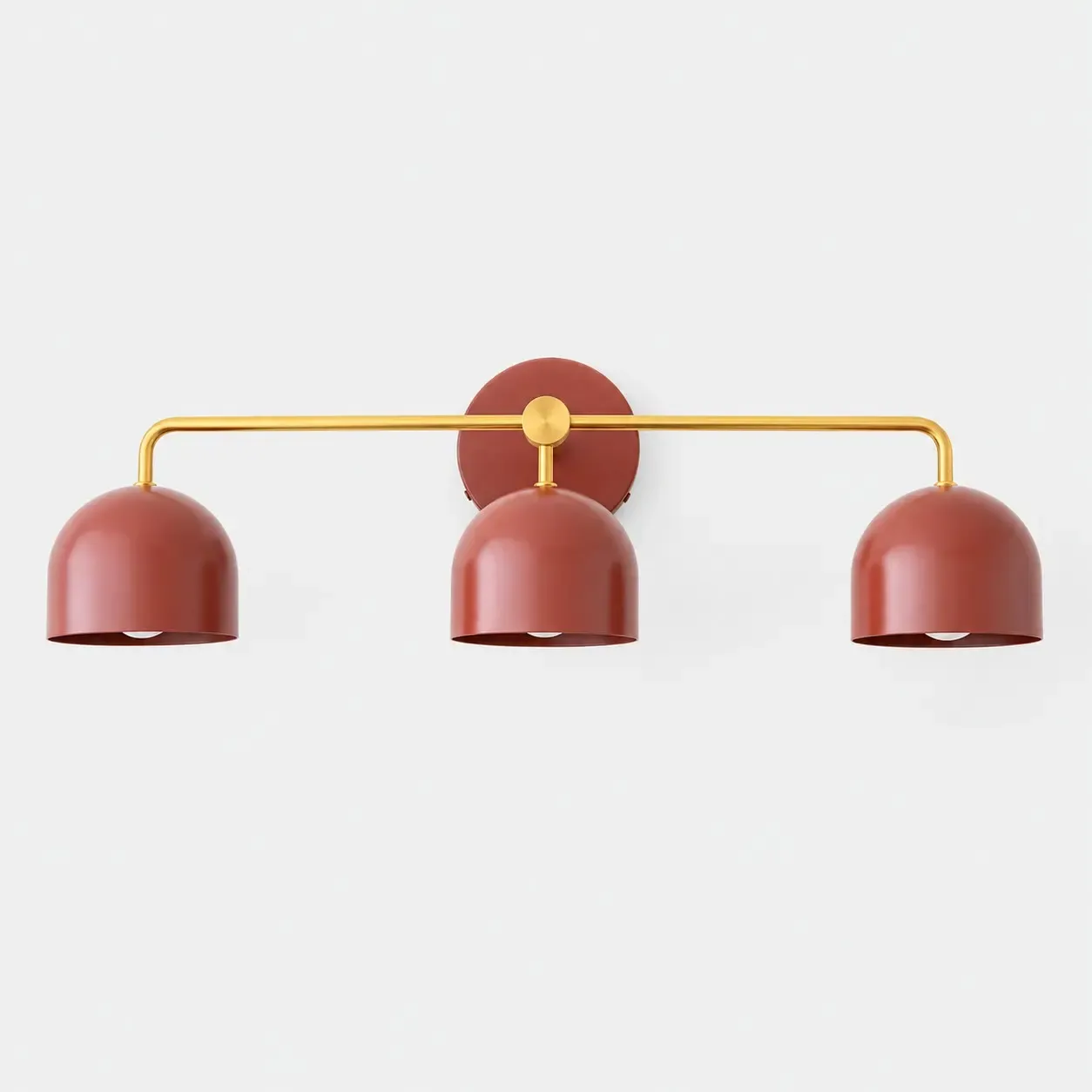 Brass three-head vanity sconce with red dome shades