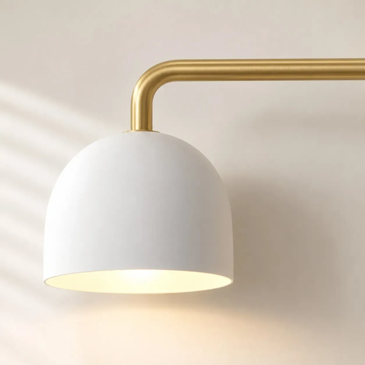 Brushed brass bar turning down into a white dome shade
