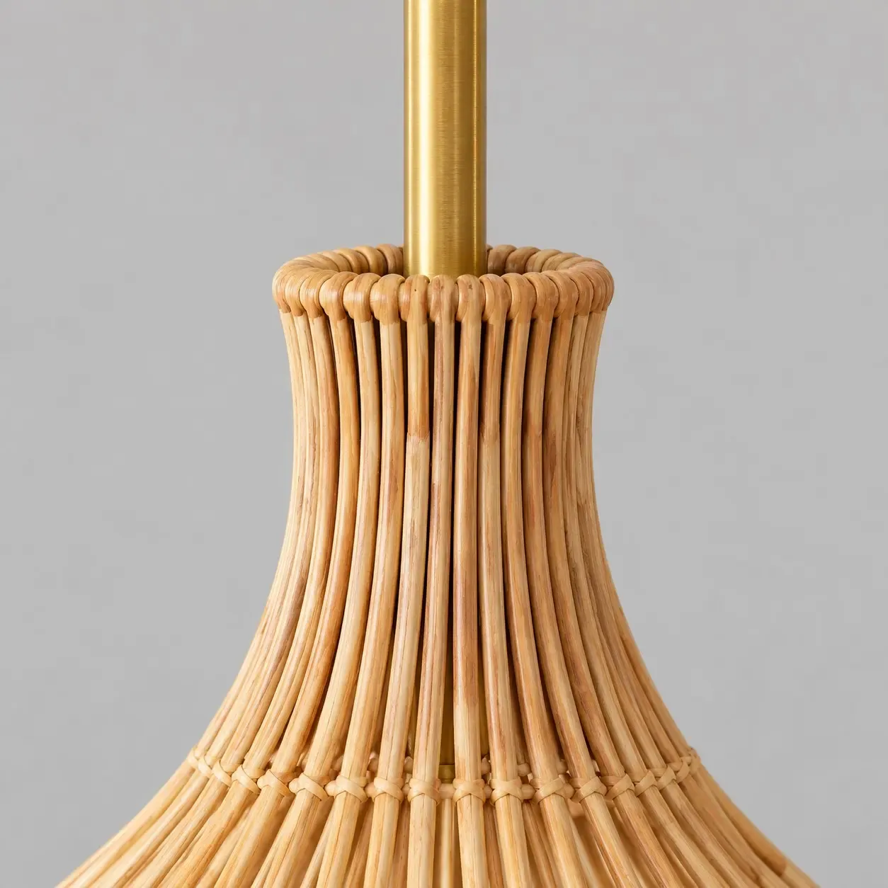 Vertical natural rattan ribs gathered at the neck under the gold-tone rod