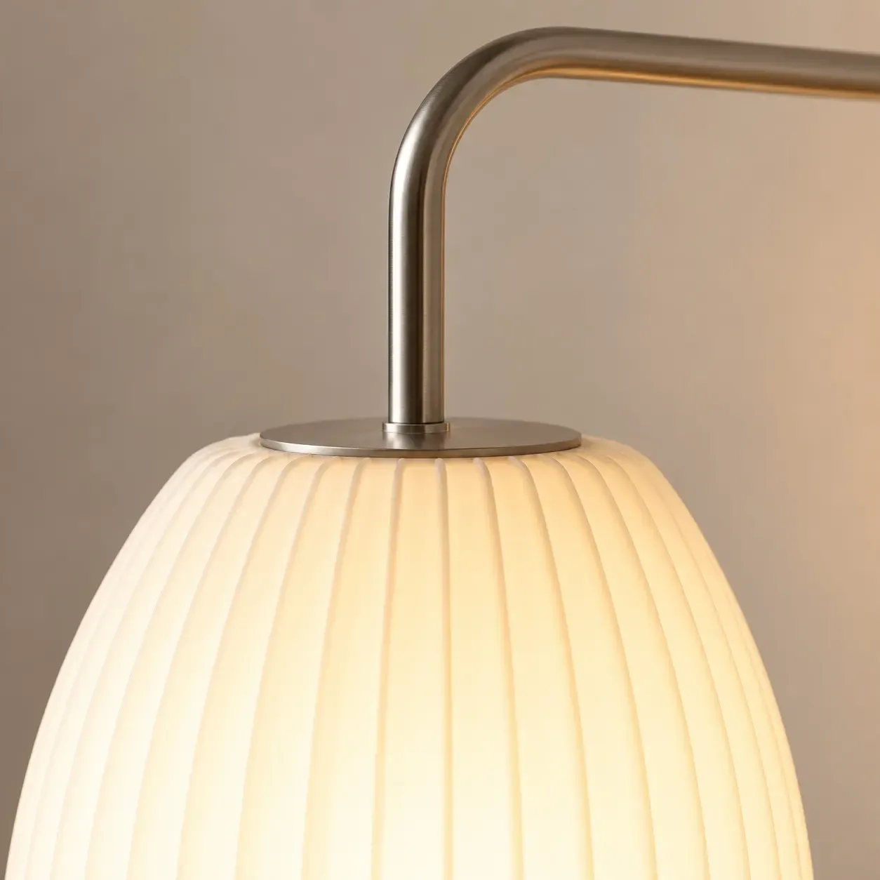 Close view of the brushed steel cap and bent arm on the oval shade