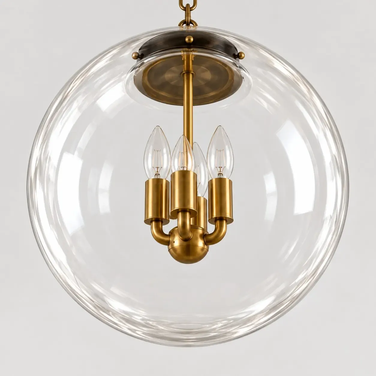 Clear glass globe with a dark collar and a four-arm brass cluster inside