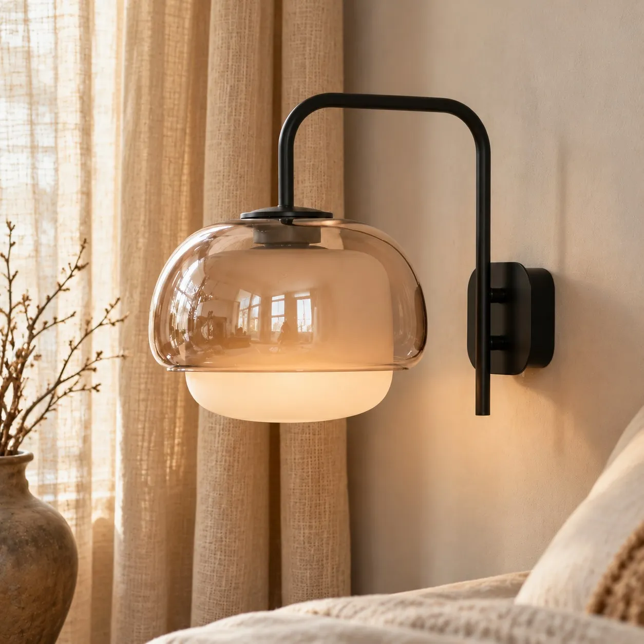 Pink sconce above a bed
