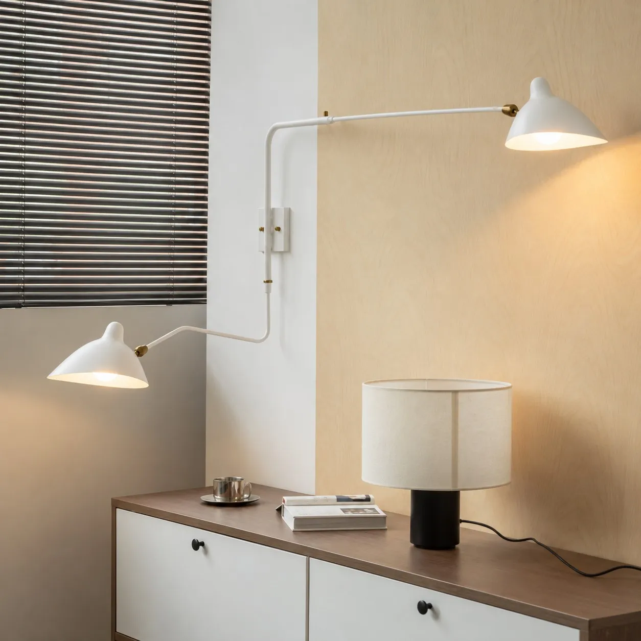 White two-light wall sconce above a sideboard