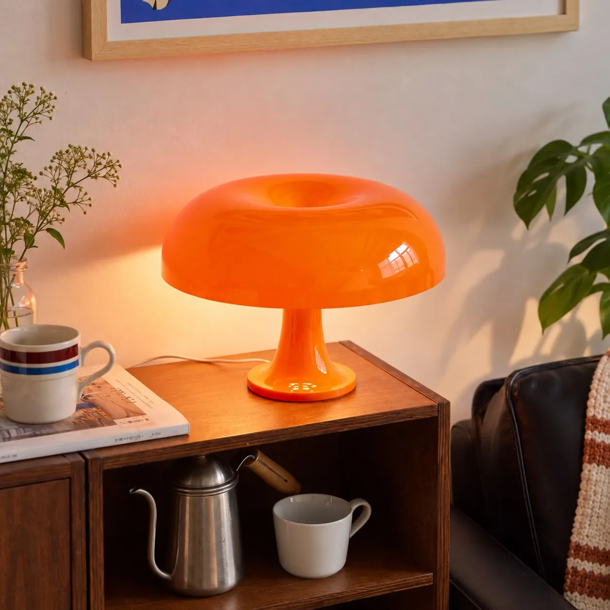 Orange lamp lit on a wooden cabinet