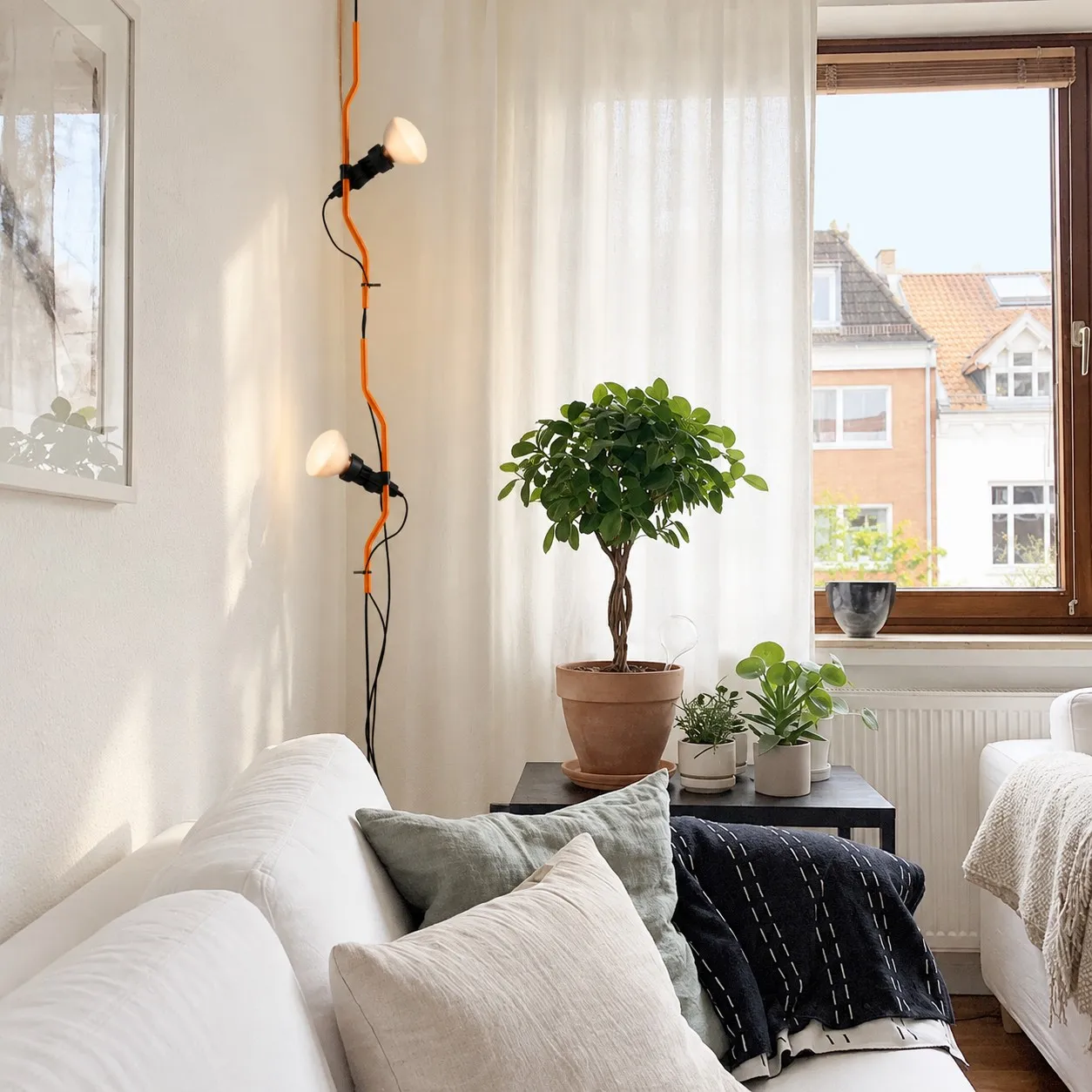 Orange two-head ceiling-to-floor lamp beside a window