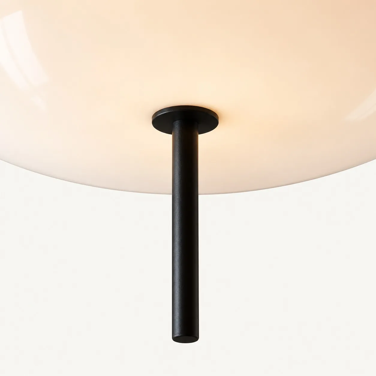 Short black stem below the glowing shade