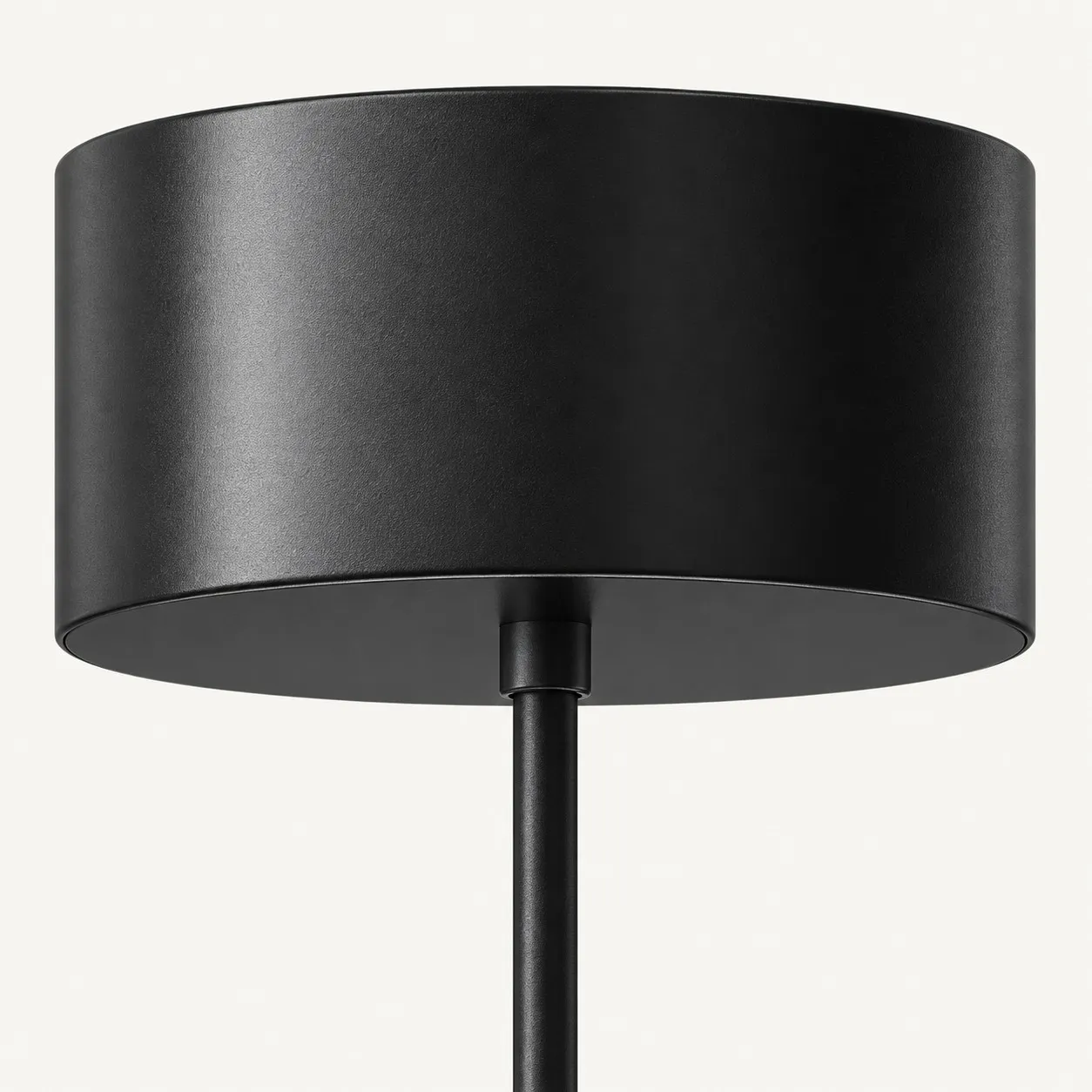 Black ceiling canopy with the cord leaving its center