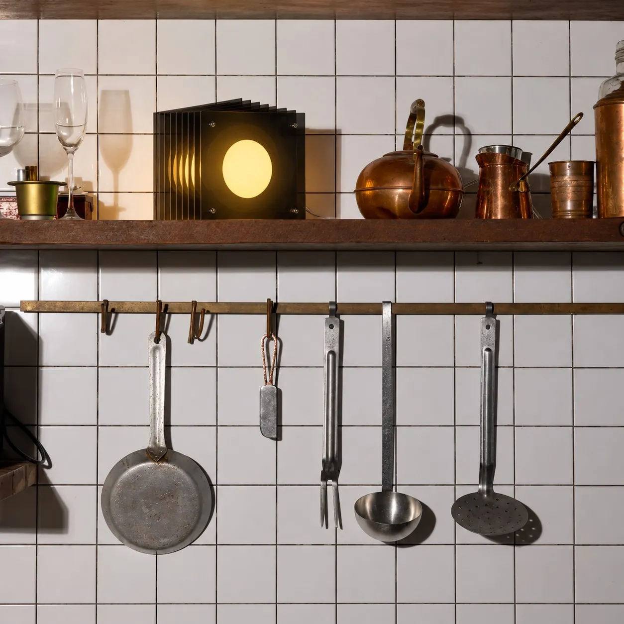 Black acrylic cube lamp on a kitchen shelf