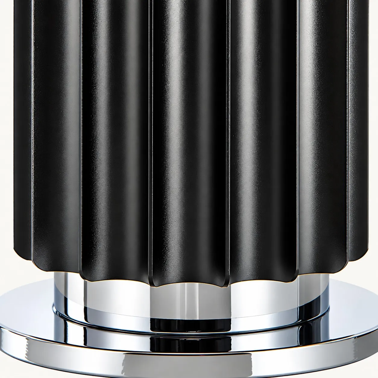 Black ribbed base on a polished metal foot